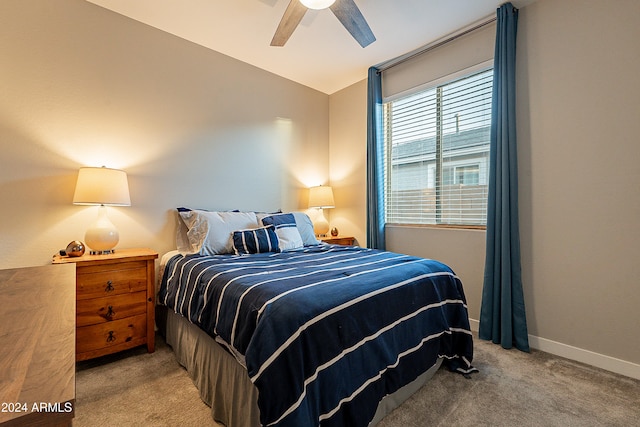 carpeted bedroom with vaulted ceiling and ceiling fan