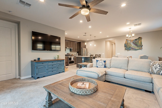 living room featuring light carpet and ceiling fan with notable chandelier