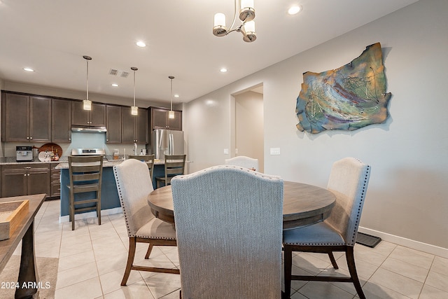 tiled dining space featuring a chandelier