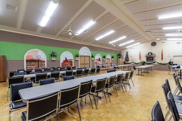 dining area with ceiling fan, lofted ceiling, and light parquet flooring