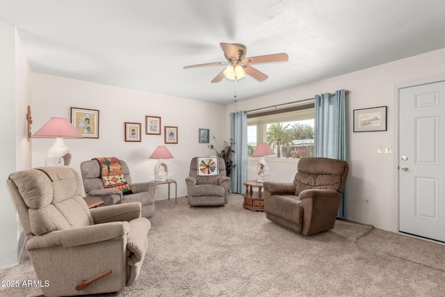 carpeted living room with ceiling fan