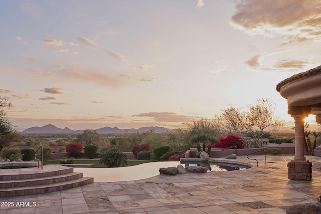 view of community with a mountain view and a patio area