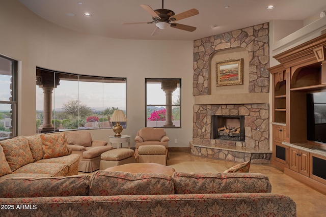 living room with a fireplace, a ceiling fan, and recessed lighting