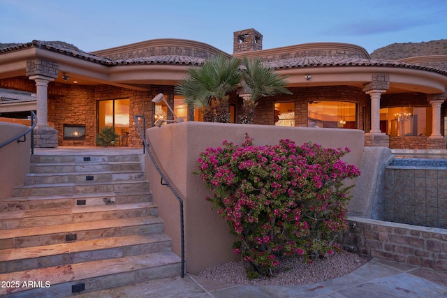 property entrance featuring a porch and a chimney