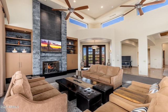 10267 E Cinder Cone Trl, Scottsdale, AZ 85262 - living room featuring a ceiling fan, arched walkways, built in features, a towering ceiling, and recessed lighting