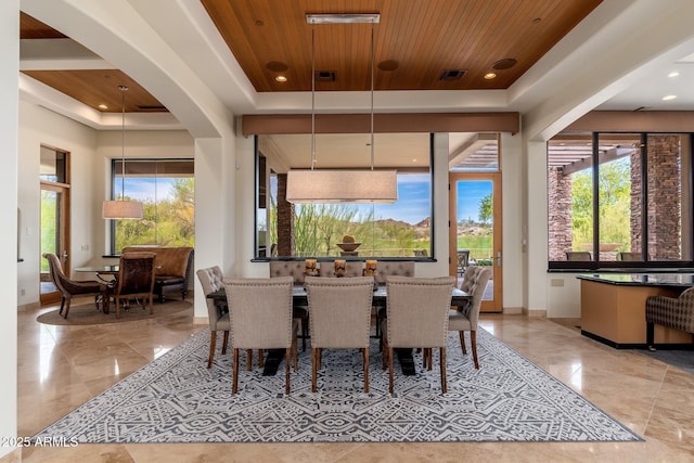 10267 E Cinder Cone Trl, Scottsdale, AZ 85262 - dining space featuring a raised ceiling, arched walkways, wooden ceiling, baseboards, and recessed lighting