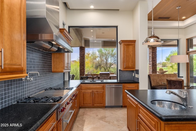 10267 E Cinder Cone Trl, Scottsdale, AZ 85262 - kitchen with appliances with stainless steel finishes, wall chimney exhaust hood, a sink, brown cabinets, and recessed lighting