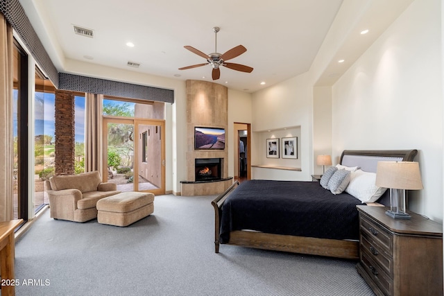 10267 E Cinder Cone Trl, Scottsdale, AZ 85262 - bedroom with carpet, recessed lighting, access to exterior, a tile fireplace, and a ceiling fan