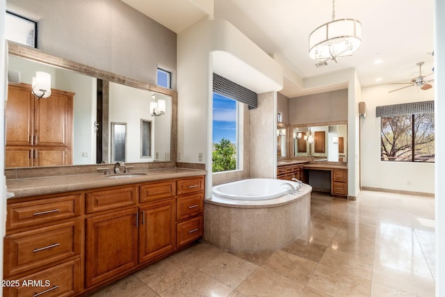 10267 E Cinder Cone Trl, Scottsdale, AZ 85262 - full bathroom featuring plenty of natural light, two vanities, a garden tub, a chandelier, and a high ceiling