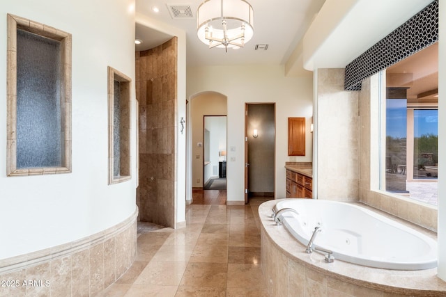 10267 E Cinder Cone Trl, Scottsdale, AZ 85262 - bathroom with a jetted tub, vanity, a chandelier, baseboards, and tile patterned flooring