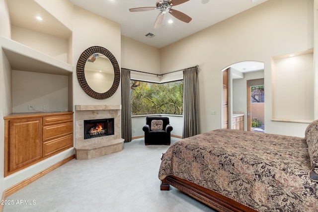 10267 E Cinder Cone Trl, Scottsdale, AZ 85262 - bedroom with carpet floors, a high end fireplace, arched walkways, recessed lighting, and ceiling fan