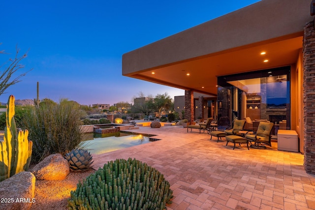 10267 E Cinder Cone Trl, Scottsdale, AZ 85262 - patio terrace at dusk with an in-ground hot tub and a patio area