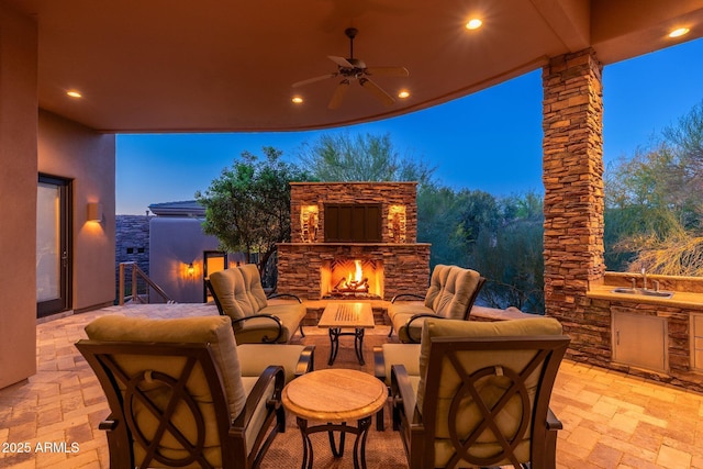 10267 E Cinder Cone Trl, Scottsdale, AZ 85262 - view of patio with a sink, an outdoor kitchen, a ceiling fan, and an outdoor living space with a fireplace