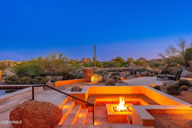 10267 E Cinder Cone Trl, Scottsdale, AZ 85262 - patio terrace at dusk with a fire pit and a patio