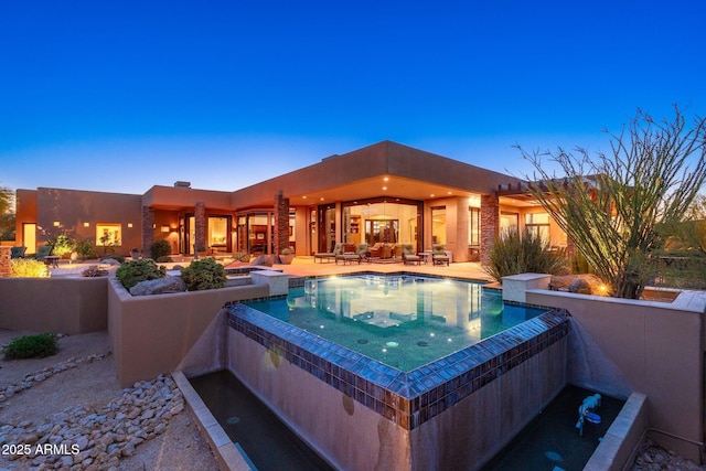 10267 E Cinder Cone Trl, Scottsdale, AZ 85262 - pool at dusk with a patio area and a pool with connected hot tub