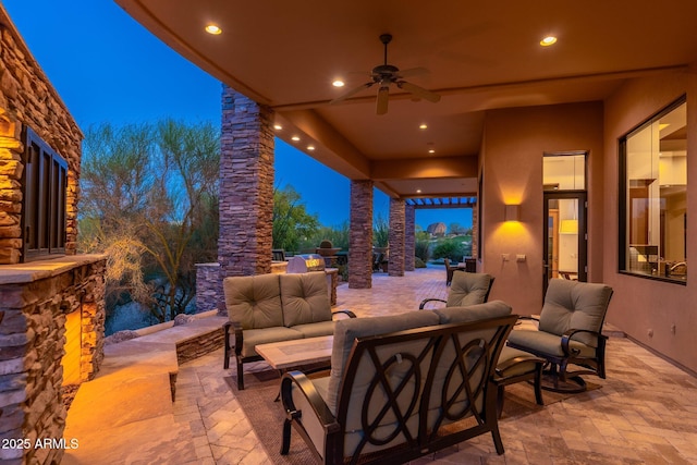10267 E Cinder Cone Trl, Scottsdale, AZ 85262 - patio at night featuring an outdoor living space with a fireplace, a patio, and a ceiling fan
