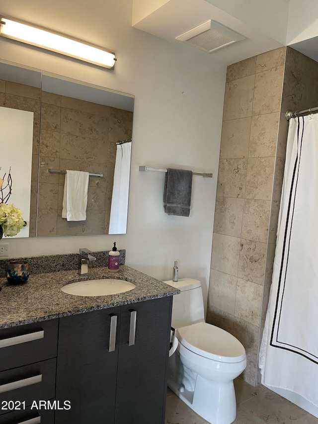 bathroom with visible vents, curtained shower, toilet, tile patterned floors, and vanity