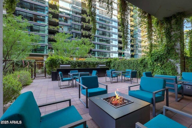 view of patio / terrace with outdoor dining area and an outdoor living space with a fire pit