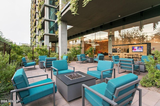 view of patio featuring an outdoor living space with a fire pit