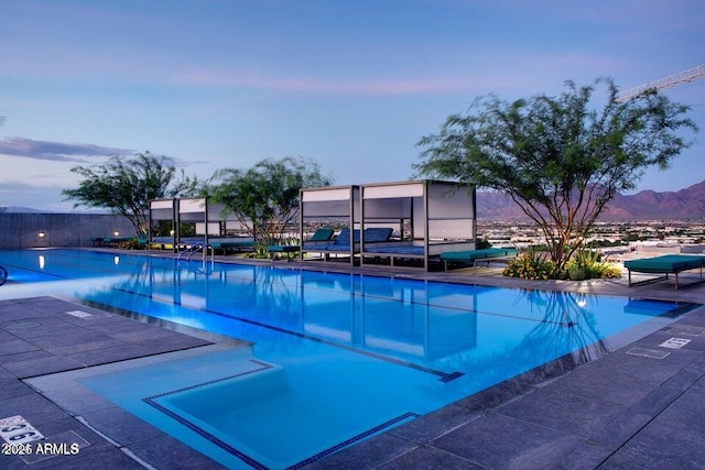 community pool with a patio and fence