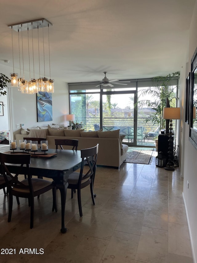 dining room featuring floor to ceiling windows and a ceiling fan