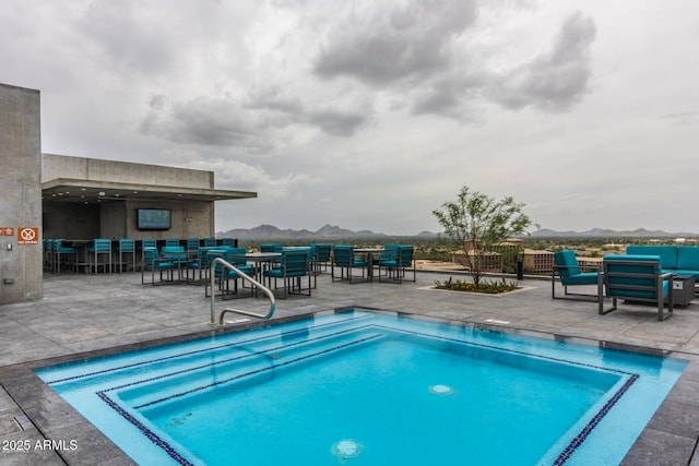 view of pool featuring a patio area, outdoor lounge area, and fence