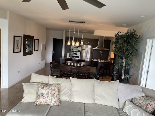 living room featuring visible vents, baseboards, and ceiling fan