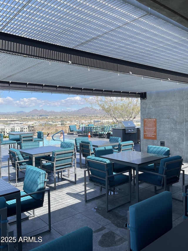 view of patio with outdoor dining space and a mountain view