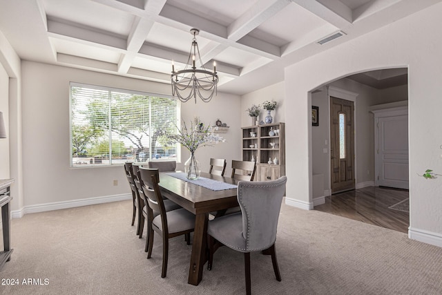 dining room with coffered ceiling, wood-type flooring, a notable chandelier, and beam ceiling