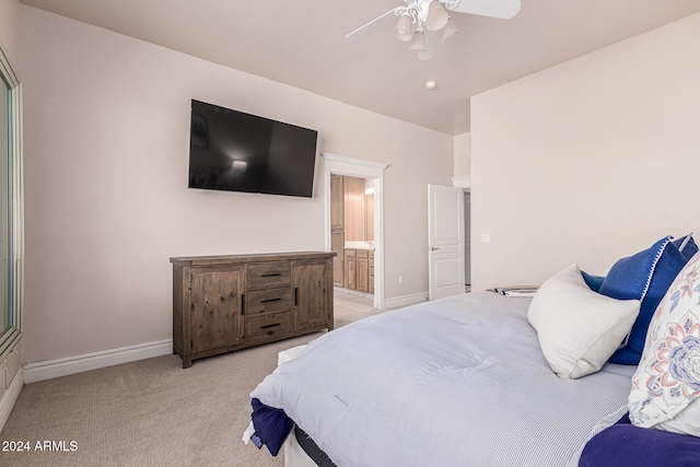 carpeted bedroom featuring connected bathroom and ceiling fan