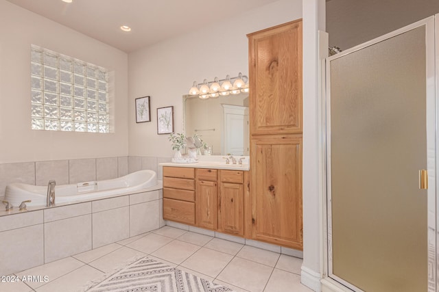 bathroom featuring vanity, shower with separate bathtub, and tile patterned flooring