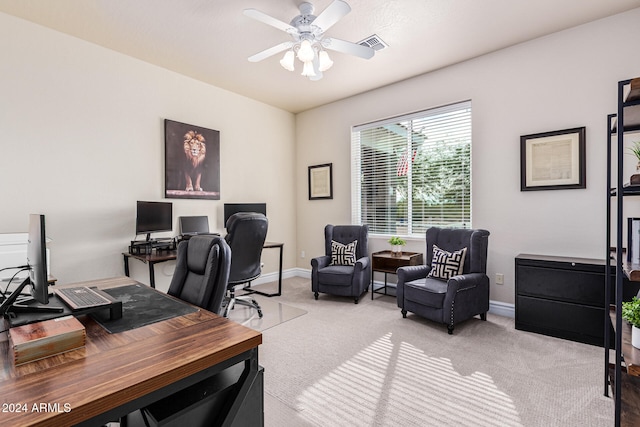 carpeted home office featuring ceiling fan