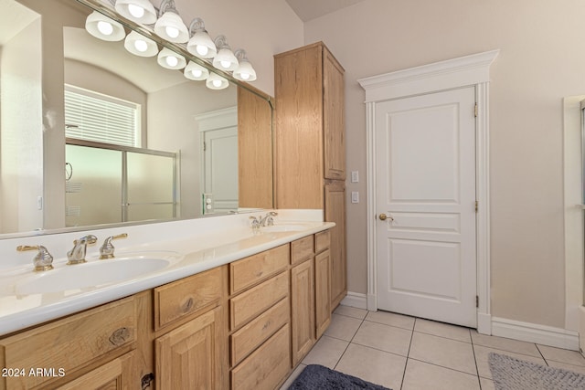 bathroom featuring vanity, tile patterned floors, and a shower with shower door