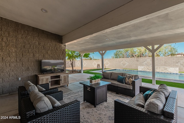 view of patio / terrace featuring a fenced in pool, outdoor lounge area, and an outdoor kitchen