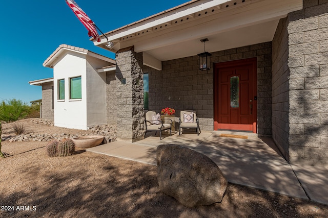 view of exterior entry featuring covered porch