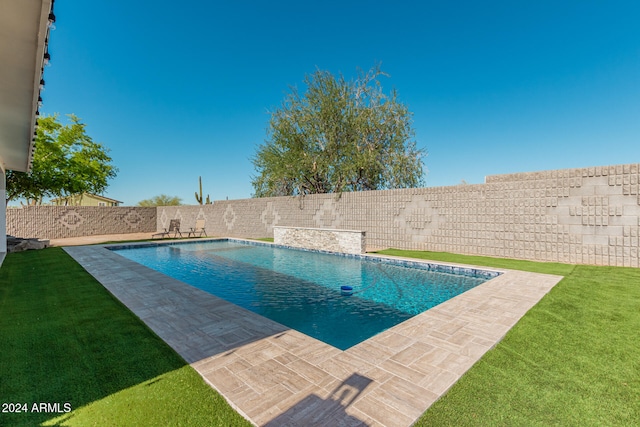 view of pool featuring a lawn