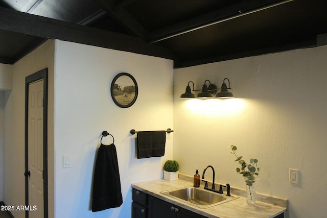 bathroom with vanity and vaulted ceiling with beams