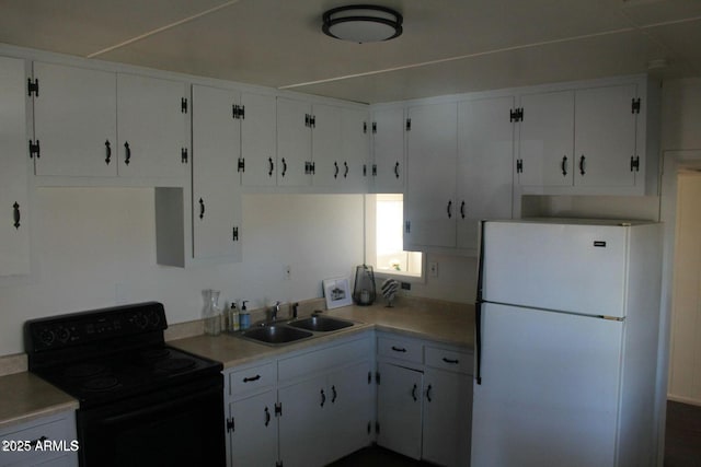 kitchen featuring black / electric stove, white cabinetry, sink, and white fridge