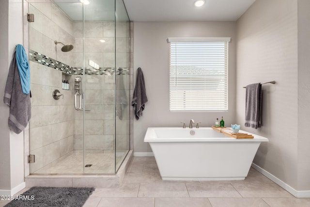 2229 N 139th Dr, Goodyear, AZ 85395 - full bathroom featuring baseboards, tile patterned flooring, a stall shower, and a soaking tub