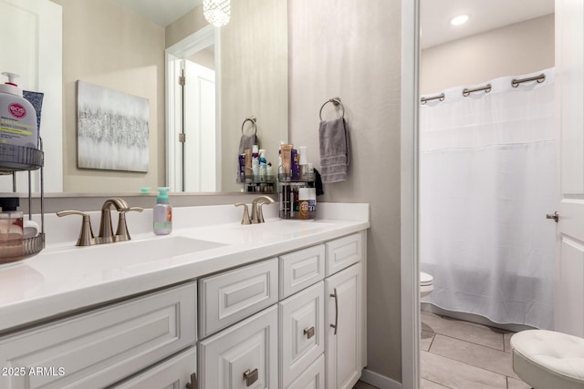 2229 N 139th Dr, Goodyear, AZ 85395 - full bathroom featuring double vanity, toilet, a shower with shower curtain, tile patterned floors, and a sink