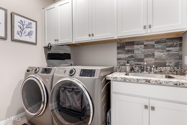2229 N 139th Dr, Goodyear, AZ 85395 - clothes washing area with cabinet space, independent washer and dryer, wet bar, and a sink