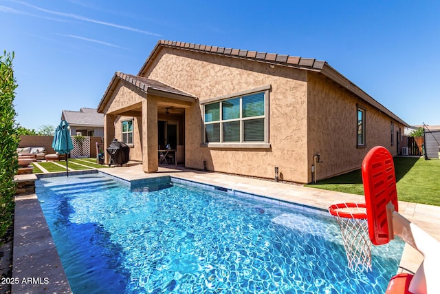 2229 N 139th Dr, Goodyear, AZ 85395 - back of house with a fenced backyard, stucco siding, a fenced in pool, a patio area, and a yard