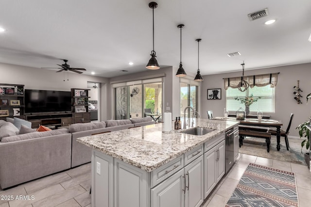 2229 N 139th Dr, Goodyear, AZ 85395 - kitchen featuring light tile patterned flooring, a sink, dishwasher, a wealth of natural light, and visible vents
