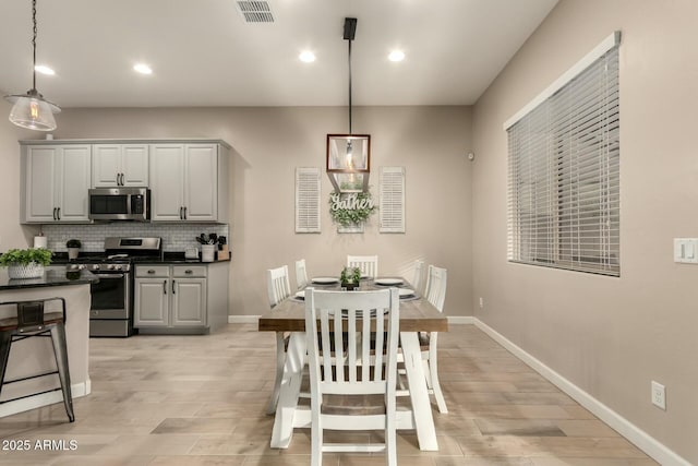 dining space featuring light wood-type flooring