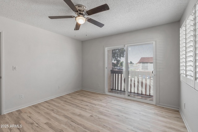 empty room with ceiling fan, wood finished floors, baseboards, and a textured ceiling