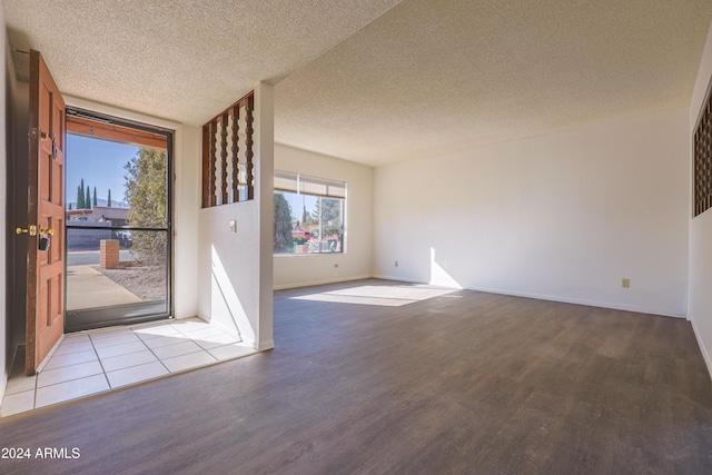 interior space featuring a textured ceiling and light wood-type flooring