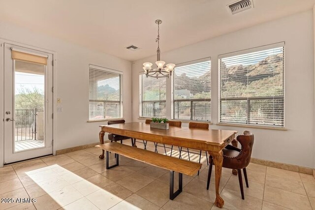 dining area featuring a chandelier, light tile patterned flooring, baseboards, and visible vents