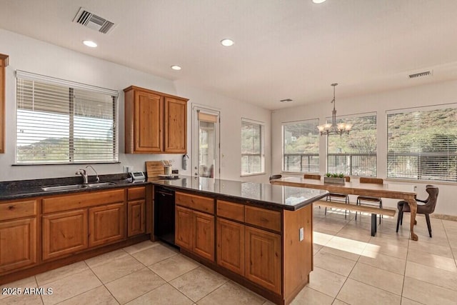 kitchen featuring a peninsula, brown cabinets, a sink, black dishwasher, and visible vents