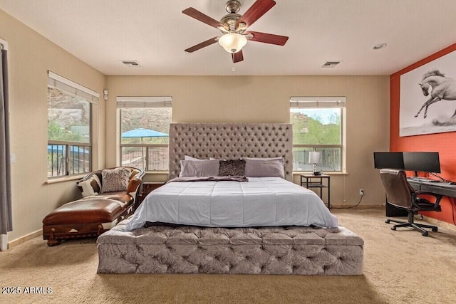 bedroom featuring a ceiling fan, visible vents, and carpet