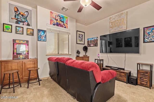 carpeted home theater room featuring visible vents and ceiling fan